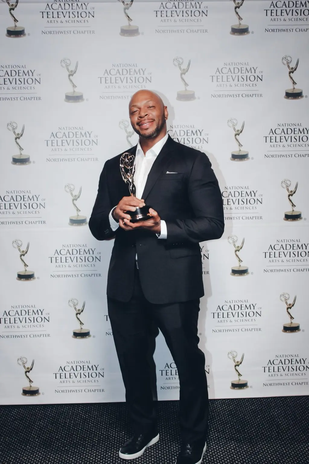 Dru Holley holding his Northwest Regional Emmy